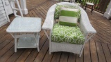 Wicker patio chair and side table with lovely outdoor cushion and pillow