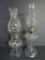 Two clear glass oil lamps, 16