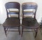 Two wooden chairs with solid seats
