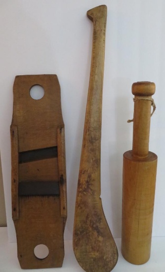 Three large wooden kitchen utensils, paddle, grater and masher,