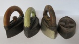 Four sad irons, three with handles, two marked AC Williams