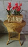 Round wicker side table and tulip arrangement in basket