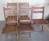 Four matching wooden folding chair and one additional chair