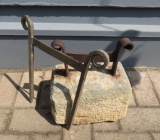 Two metal boot scrapers, one mounted in stone