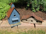Two wood birdhouses with metal roofs