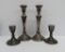 Two sets of weighted sterling candlesticks, 8 3/4