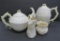 Four pieces of Belleek china, two tea pots, creamer and sugar