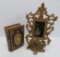 Ornate pedestal metal picture frame with tin type of baby and 1849 German prayer book