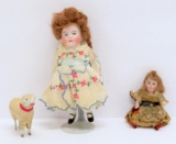 Two dollhouse bisque dolls and cotton sheep