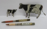 Two metal DeLaval tin advertising pieces, cow and calf, and livestock advertising pencils