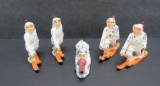 Four Manoil Finn on skis lead toy soldiers and sniper