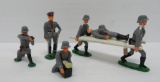 Six Bill Holt toy soldiers and gurney, 3 1/4