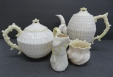 Four pieces of Belleek china, two tea pots, creamer and sugar