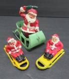 Three metal Santa figures, Santa in sled 3 1/2