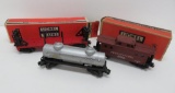 Three Lionel cars with two Lionel boxes