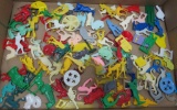 About 115 plastic Cracker Jack toy prizes, tops, whistles, colorful animals,vehicles, and people