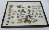 Assorted lot of military insignia, hat badges, medals and more