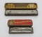Two vintage harmonicas in metal containers, Hotz Harmonica King & Opera