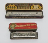Two vintage harmonicas in metal containers, Hotz Harmonica King & Opera