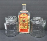 Two glass cigar jars and large glass Gordon's Gin bottle
