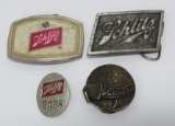 Three Schlitz belt buckles and employee badge