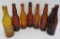 7 amber Schlitz, Milwaukee Lager bottles and one Graf's, 9 1/2