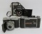 Four vintage cameras and meter