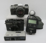 Three vintage 35 mm cameras and Minolta Auto Meter IV F