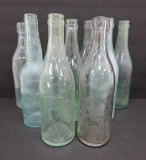 Nine Aqua Schlitz bottles, 9 1/2