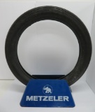 Metzler motorcycle tire display with metal stand and tire
