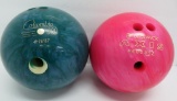 Two vintage MCM colored bowling balls, Fuschia Brunswick Axis and teal & purple Columbia 300