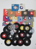 About 35 vintage 45 rpm records, some with sleeves