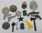 17 Cracker Jack and Vending prizes, badges, and toy gun model charms