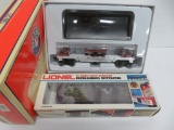 Two Lionel train cars with boxes, Wisconsin Central Log Dump car and Rolling Stock