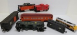 Seven plastic train cars, Lionel and Cat