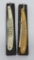 Two ornate straight razors and cases