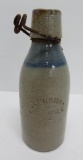 Blue and grey stoneware bottle, EL Hustings, Milwaukee, 7 1/2