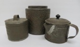 Three ornate tin kitchen canisters and coffee boiler