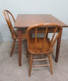 Oak table and two bow back chairs