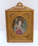signed portrait in ornate metal frame, woman with hat, 7 1/2