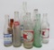 8 vintage soda bottles, 7 oz to 32 oz