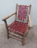 Adirondak rustic arm chair with leather woven seat and back