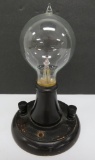 Very cool vintage light bulb in stand, filament intact