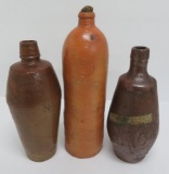 Three stoneware liquor bottles, 9