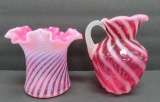 Two pieces of Fenton cranberry swirl, pitcher and hat vase