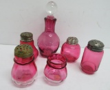 Six pieces of vintage cranberry glass, bottle with stopper, shakers and toothpick holder
