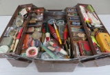 Vintage metal tackle box, filled with lures, wood bobbers, jigs, and Champion spark plugs