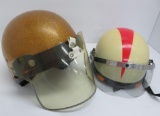 Two vintage motorcycle helmets with visors
