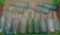 13 embossed soda bottles, clear, green and aqua