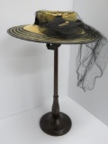 Vintage straw and netting hat with wooden hat stand, New York